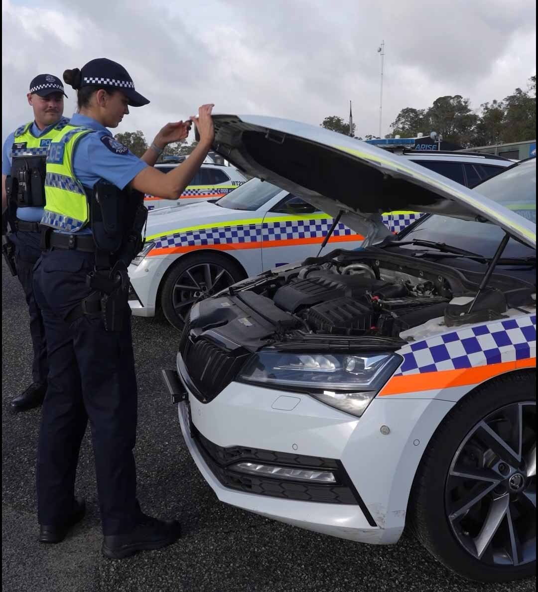 Police Recruit Checking Police Vehicle