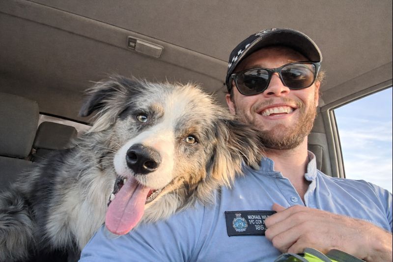 Selfie of Michael from West Coast Cops with a cute dog in a vehicle.