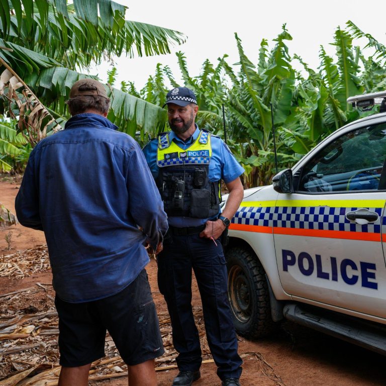 Male police officer speaking to a local in regional Western Australia.